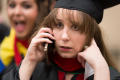 Thumbnail image of item number 1 in: '[Graduating Student on her phone at her Commencement Ceremony]'.