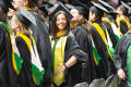Photograph: [Masters Recipient Smiling for Photo at Commencement Ceremony]