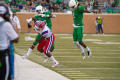 Photograph: [North Texas Football player evades opposing player]