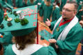 Photograph: [Undergraduate Student Wearing Decorated Cap at Commencement Ceremony]