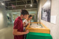 Photograph: [Students Looking at Exhibition Work]