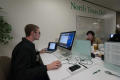 Photograph: [Two NT Daily staffers working at desks]