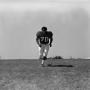 Photograph: [Football player #70, Jimmy Franklin, jogging toward the camera]