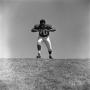 Photograph: [Football player #70, Jimmy Franklin, runs forward arms in a T, 2]