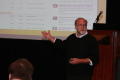 Photograph: [Photograph of man giving a presentation at TDNA conference]
