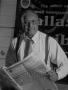 Photograph: [Samuel Wick holding The Dallas Post Tribune]