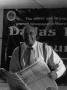 Photograph: [Samuel Wicks holding The Dallas Post Tribune]