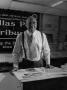 Photograph: [Samuel Wicks standing near drafting tables #2]