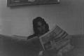 Photograph: [Photograph of Byrd Williams IV reading a newspaper]