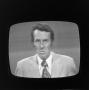 Photograph: [Reporter on television]