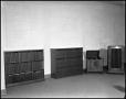 Photograph: [Record Player and Two Bookcases Inside an Unidentified Building]