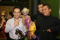 Photograph: [Man poses with Thai puppet]