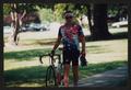 Photograph: [Cyclist Chuck Taylor walking with his bike: Lone Star Ride 2002 even…