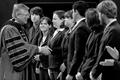 Photograph: [Norval Pohl shakes hands with Moot Court team]