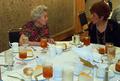 Photograph: [Katherine Perry and Gloria Goyne converse at 2003 CPS training event]