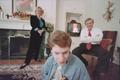 Photograph: [Michael Rowlett and parents in their living room]