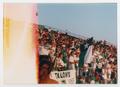 Photograph: [UNT flag displayed by members of Talons at a football game]
