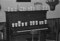 Photograph: [Cups on a piano at the home of Willard Watson, "The Texas Kid", 5]