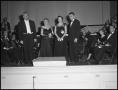 Photograph: [People on stage with the orchestra]