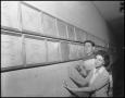 Primary view of [Two students looking at wall of awards]