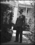 Photograph: [President McConnell in front of a house]