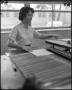 Photograph: [Woman working in the print shop]