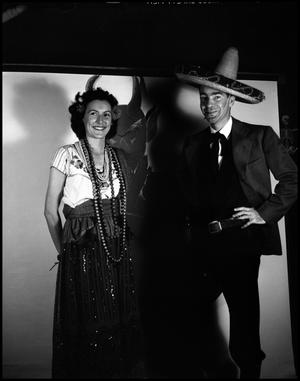 Primary view of object titled '[Dr. C.E. Shuford in a sombrero posing with unidentified woman]'.