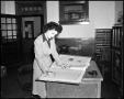 Photograph: [Woman working in Campus Chat office]