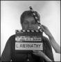 Photograph: [Portrait of Lewis Abernathy behind a clapperboard]