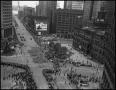 Photograph: [Aerial photograph of a parade marching downtown, 1]