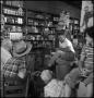 Photograph: [Man speaking in a store]