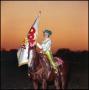 Photograph: [Girl holding a flag rides on horseback]