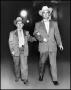 Photograph: [Rex Cauble walking with Lewis Cauble]