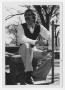 Photograph: [Bill Nelson on a stone stool]