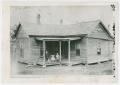 Photograph: [Photograph of three children on the porch of a wooden house]