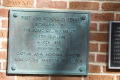 Photograph: [Plaque on Brick Wall]
