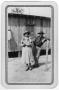 Photograph: [Woman and man pose outside a building in a Texas Civilian Conservati…