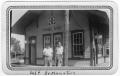 Photograph: [Two men waiting at the Pineland railroad station]