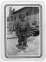 Photograph: [ Man stands outside CCC camp buildings]