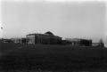 Photograph: [Administration Building Viewed Across a Field]
