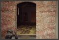 Photograph: [Arched Doorway in Brick Wall]
