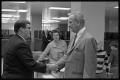 Photograph: [Lyndon B. Johnson shakes hands with reporter]