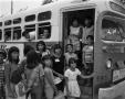 Photograph: [Children Entering a Bus]