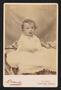 Photograph: [Portrait of an Unknown Child Sitting on a Blanket]