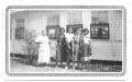 Photograph: [Group of  Teachers Standing in Front of a Sunday School Building]