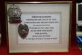 Photograph: [Image of frame containing Junior Police Badges with description]