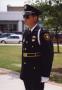 Photograph: [APD Honor Guard officer, Gary Krohn, standing at attention]
