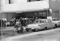 Photograph: [Casket being loaded into a hearse at Parkland Hospital]