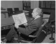 Photograph: [J.W. Edgar reading The Austin Statesman newspaper]