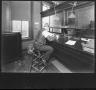 Photograph: [Southern Pine Lumber Company Office Worker at Accounts Desk]